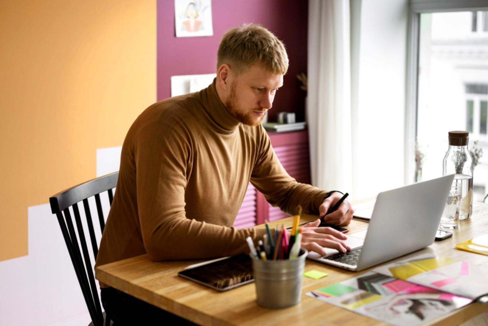 Person reviewing financial priorities on laptop with notes